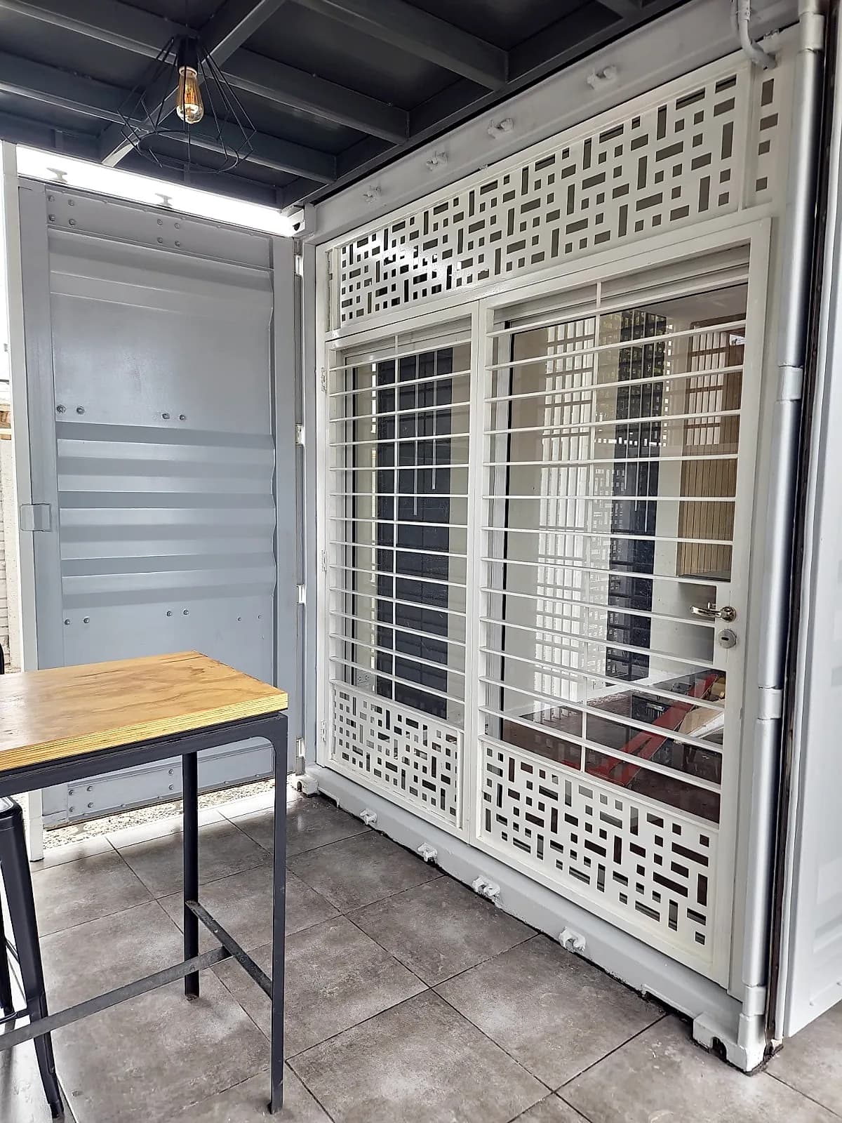 Puerta ventana con rejas de seguridad y paños decorativos metálicos